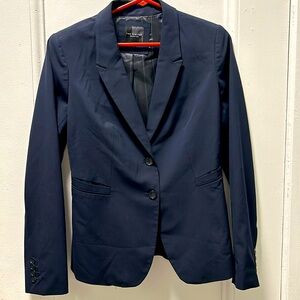 A classic navy blue blazer that can be worn with anything.